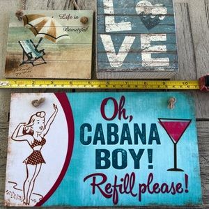 Three Beach themed signs. Two hang with twine and the third LOVE block stands